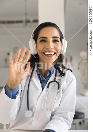 Smiling physician start online consultation using videocall app, webcam view 120505494