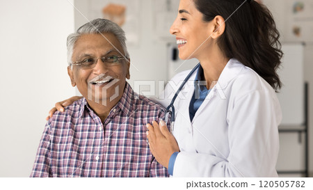 Brazilian doctor hugs old smiling male patient 120505782