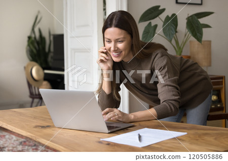 Woman working online, smiling, having positive emotions, working from homeoffice 120505886