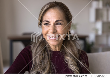 Happy thoughtful Hispanic retired older senior lady posing for portrait 120505888
