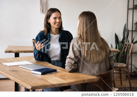 Two colleagues leading positive conversation during meeting in office Two colleagues leading positive conversation during meeting in office 120506018