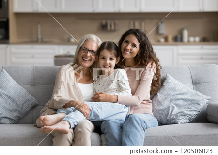 Portrait of pretty three generational family women posing for camera Portrait of pretty three generational family women posing for camera 120506023