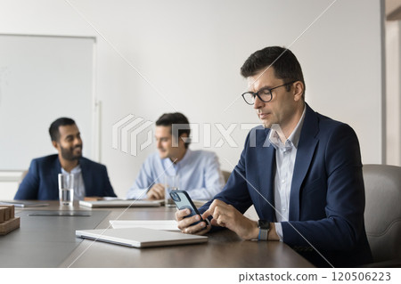 Serious Caucasian business company leader man typing on smartphone 120506223