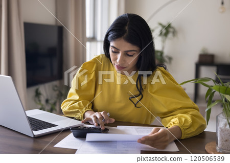 Focused busy Indian freelance accountant woman checking financial documents Focused busy Indian freelance accountant woman checking financial documents 120506589