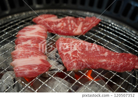 Korean barbecue, closeup of raw beef sirloin on grill 120507352