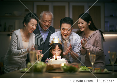 three generation asian family celebrating little girl's birthday at home 120507737
