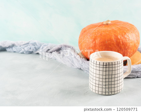 Pumpkin spiced latte coffee on turquoise background with orange squash Pumpkin spiced latte coffee on turquoise background with orange squash 120509771