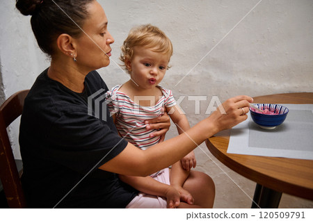 Mother and child at table with colorful bowl of food 120509791