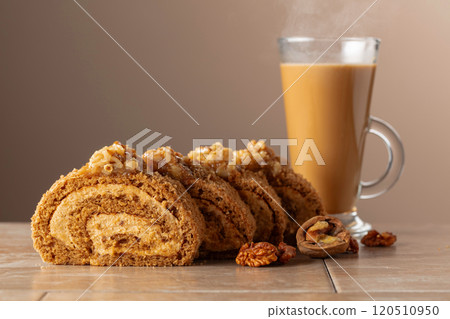 Dessert with walnuts and coffee latte on a beige background. Dessert with walnuts and coffee latte on a beige background. 120510950
