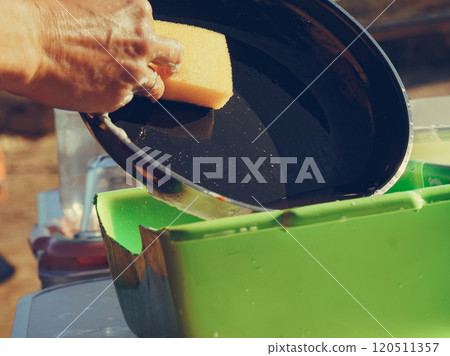 Woman washing dishes in bowl, capming outdoor Woman washing dishes in bowl, capming outdoor 120511357