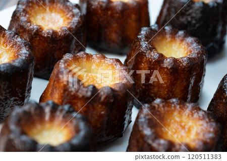 Canneles de bordeaux, traditional French sweet dessert with white table background 120511383