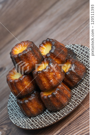 Canneles de bordeaux, traditional French sweet dessert with white table background Canneles de bordeaux, traditional French sweet dessert with white table background 120511393