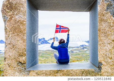 Tourist on stone sculpture in mountains, Norway Tourist on stone sculpture in mountains, Norway 120511640