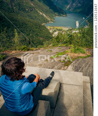 Tourist enjoying Geirangerfjord from viewing point Tourist enjoying Geirangerfjord from viewing point 120511647