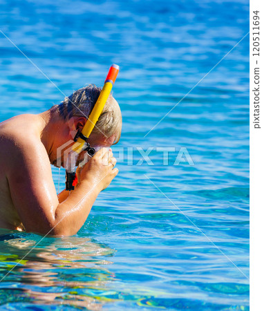 Man with snorkeling tube in sea 120511694
