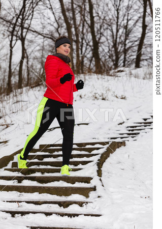 Woman wearing sportswear exercising during winter 120511766