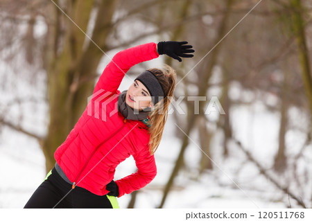 Woman wearing sportswear exercising during winter 120511768