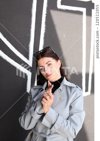 young pretty brunette woman posing emotional outside on neutral background young pretty brunette woman posing emotional outside on neutral background 120511955