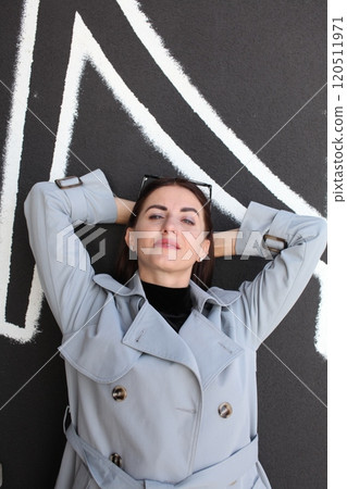 young pretty brunette woman posing emotional outside on neutral background young pretty brunette woman posing emotional outside on neutral background 120511971