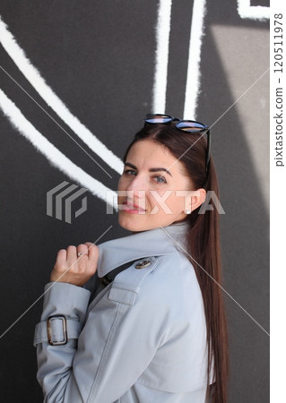 young pretty brunette woman posing emotional outside on neutral background young pretty brunette woman posing emotional outside on neutral background 120511978