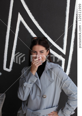young pretty brunette woman posing emotional outside on neutral background young pretty brunette woman posing emotional outside on neutral background 120511999