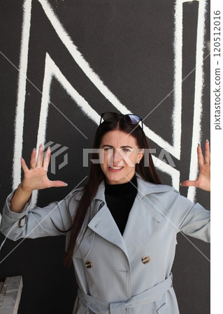 young pretty brunette woman posing emotional outside on neutral background 120512016