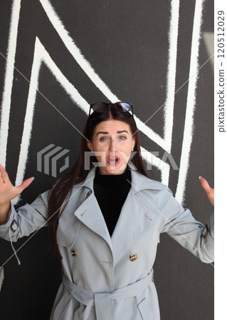 young pretty brunette woman posing emotional outside on neutral background young pretty brunette woman posing emotional outside on neutral background 120512029