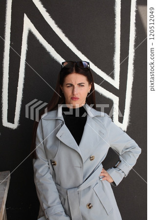 young pretty brunette woman posing emotional outside on neutral background young pretty brunette woman posing emotional outside on neutral background 120512049