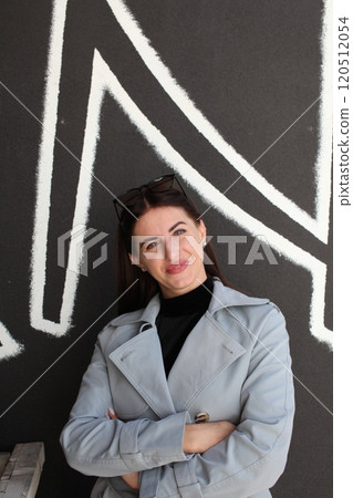 young pretty brunette woman posing emotional outside on neutral background young pretty brunette woman posing emotional outside on neutral background 120512054