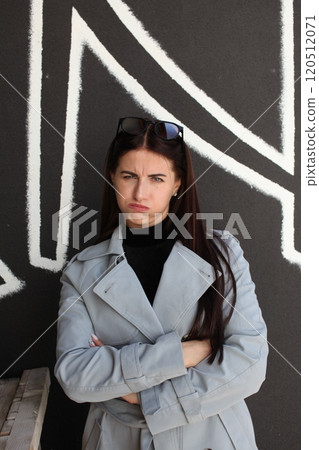 young pretty brunette woman posing emotional outside on neutral background young pretty brunette woman posing emotional outside on neutral background 120512071