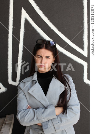 young pretty brunette woman posing emotional outside on neutral background young pretty brunette woman posing emotional outside on neutral background 120512072