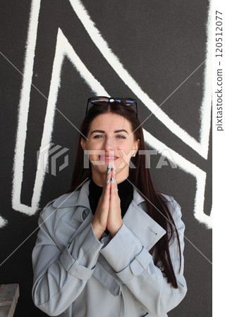 young pretty brunette woman posing emotional outside on neutral background 120512077