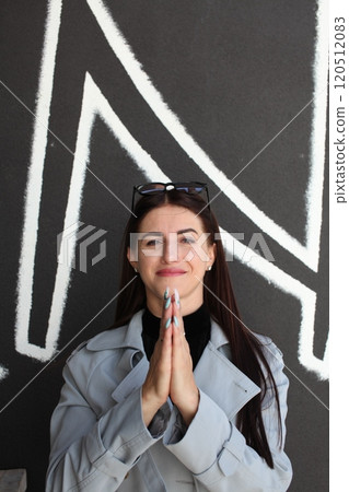 young pretty brunette woman posing emotional outside on neutral background 120512083