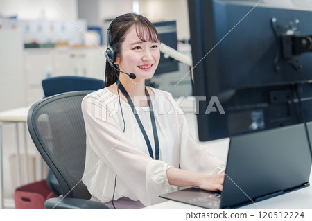 A female operator serving customers at a call center 120512224