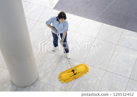 Image of building cleaning: Middle-aged female cleaning staff mopping the floor 120512452