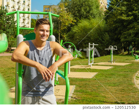 Young man relaxing after outdoor workout Young man relaxing after outdoor workout 120512530
