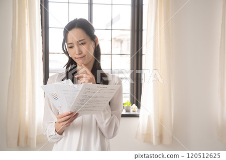 A businesswoman having trouble looking at documents A businesswoman having trouble looking at documents 120512625