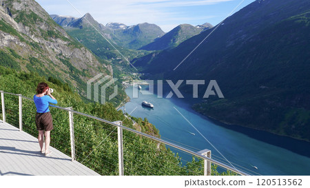 Tourist taking photo of fjord landscape, Norway 120513562