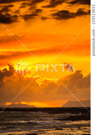 Sunset over sea surface, dark clouds. 120513653
