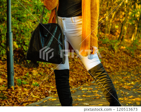 Woman wearing orange autumn cardigan outdoor Woman wearing orange autumn cardigan outdoor 120513673