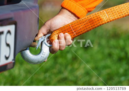 Male hand attaching towline to car Male hand attaching towline to car 120513789