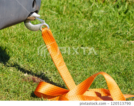 Tow hook with orange strap on car. Towing equipment. 120513790