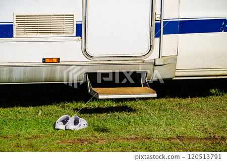 Shoes clogs in front of camper car step 120513791