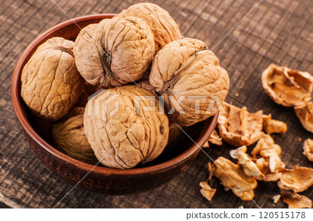Walnut kernels and whole walnuts on old wooden 120515178