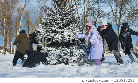 Cheerful schoolgirls having a snowball fight in a winter wonderland during a festive photo shoot in the park Cheerful schoolgirls having a snowball fight in a winter wonderland during a festive photo shoot in the park 120515298