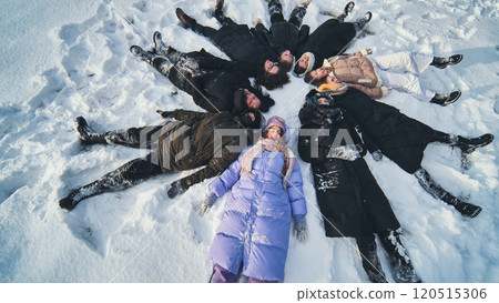 Young students making snow angels in the snow during a winter photo shoot Young students making snow angels in the snow during a winter photo shoot 120515306