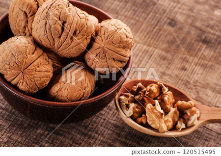 peeled nuts with shell.Walnut kernels and whole walnuts on old wooden peeled nuts with shell.Walnut kernels and whole walnuts on old wooden 120515495