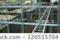 A building construction site visible through a metal fence on a Japanese street 120515704
