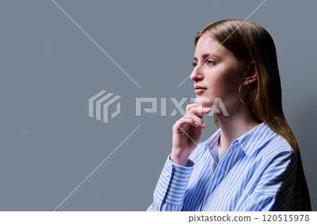 Portrait in profile beautiful thoughtful young woman on gray background 120515978