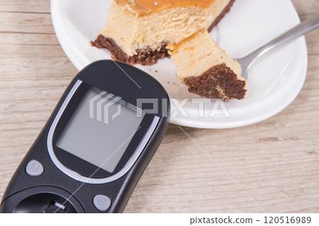 Glucometer for measuring sugar level and sweet cheesecake. Nutrition during diabetes Glucometer for measuring sugar level and sweet cheesecake. Nutrition during diabetes 120516989
